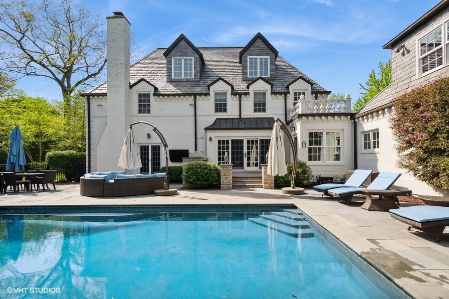 626 Warwick Road Kenilworth, IL 60043 - Photo 42 of 56 a view of a house with pool and chairs