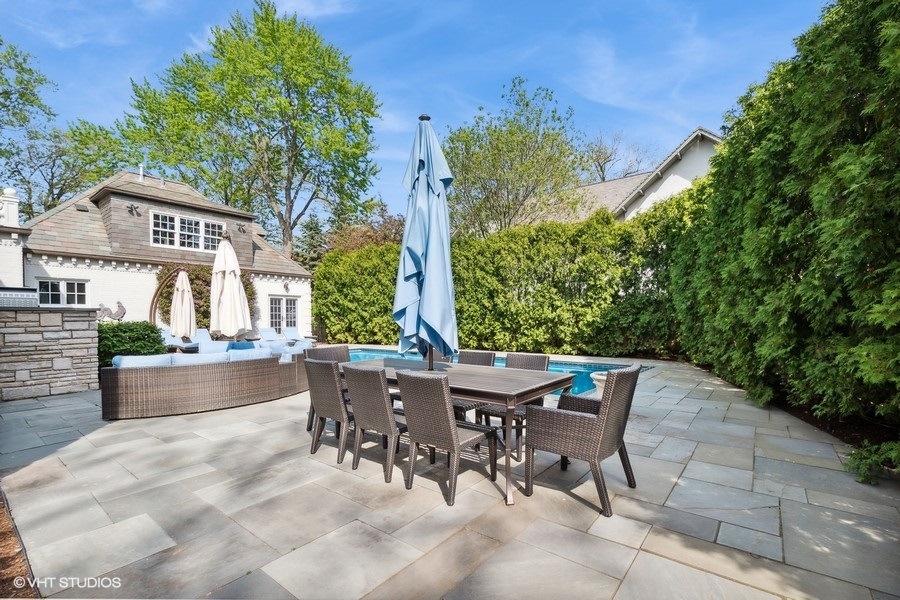 626 Warwick Road Kenilworth, IL 60043 - Photo 45 of 56 a view of a patio with a table and chairs and potted plants