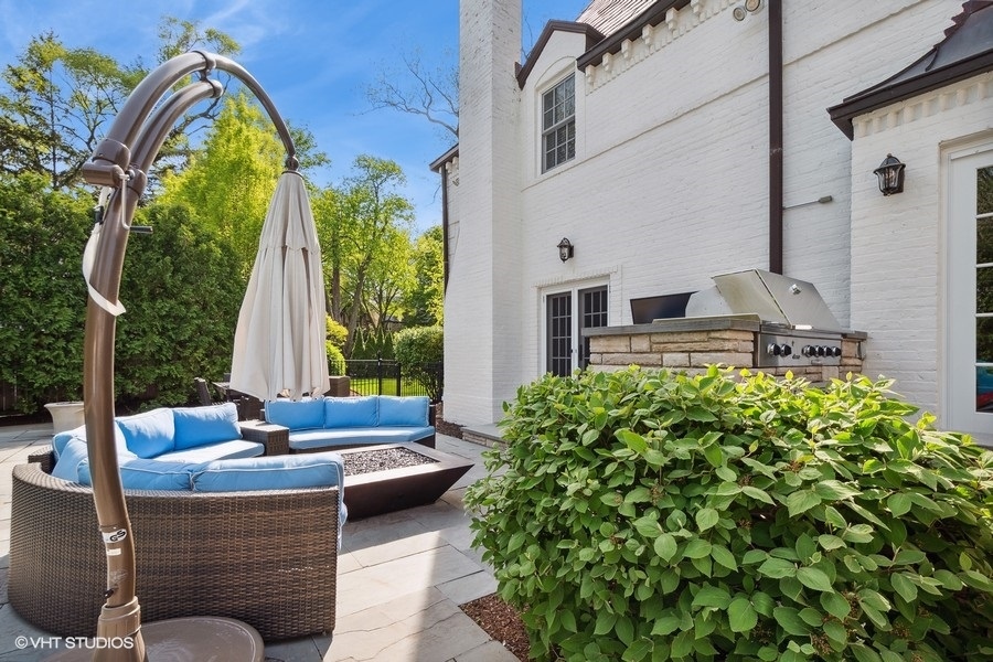 626 Warwick Road Kenilworth, IL 60043 - Photo 47 of 56 a view of a patio with couches table and chairs and potted plants