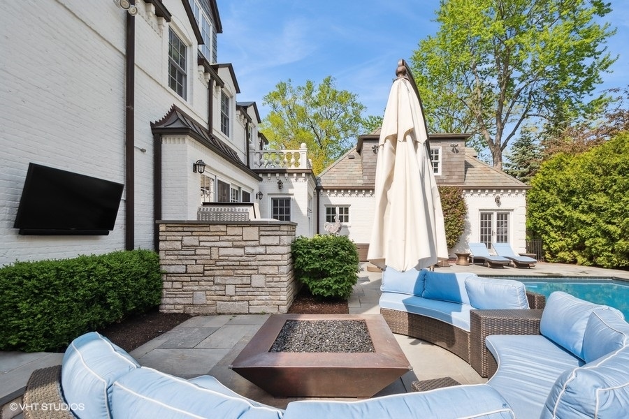 626 Warwick Road Kenilworth, IL 60043 - Photo 48 of 56 a view of a house with couches chair and a fire pit