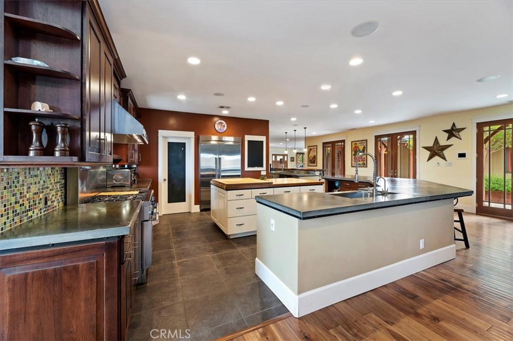 16420 Rocky Glen Road Perris, CA 92570 - Photo 21 of 74 a kitchen with stainless steel appliances granite countertop a sink stove and refrigerator