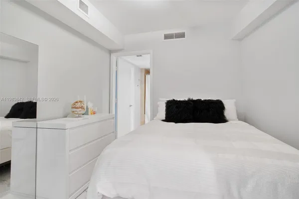 a bedroom with a bed and a cabinets