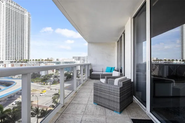 a balcony with furniture and city view
