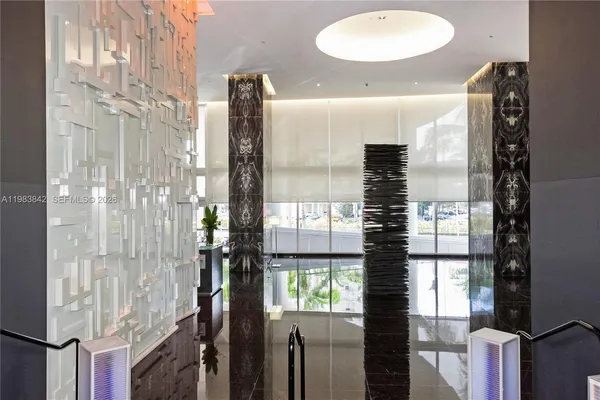 a bathroom with a glass shower door and a sink