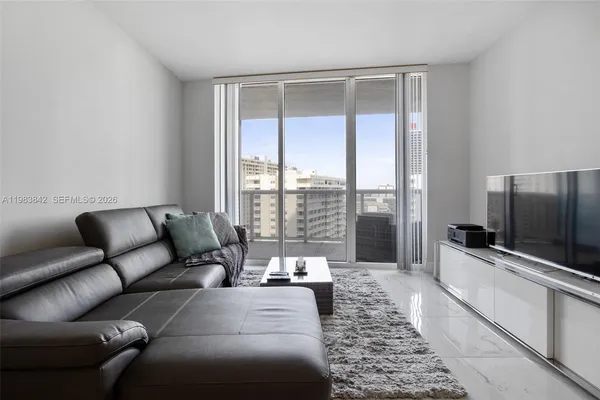 a living room with furniture and a flat screen tv