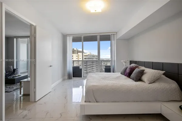 a bedroom with a large bed and a large window