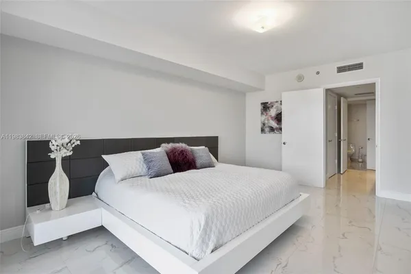 a bedroom with a bed and a couch