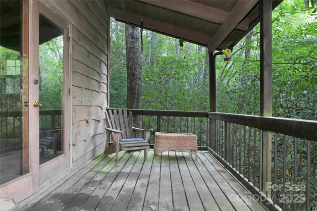 a view of balcony with wooden floor and outdoor seating