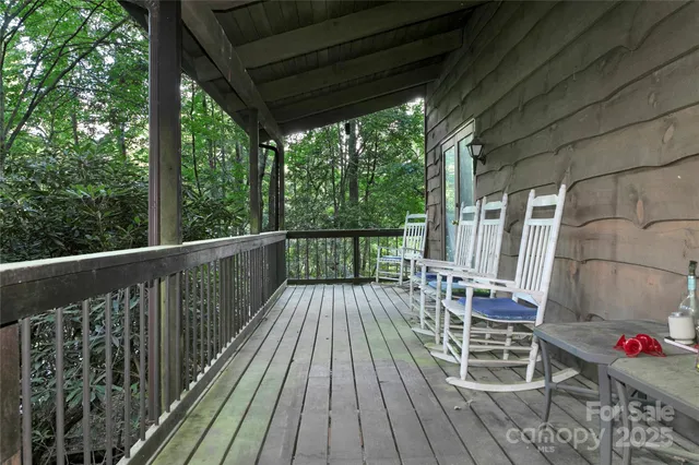 a view of balcony with wooden floor and outdoor seating