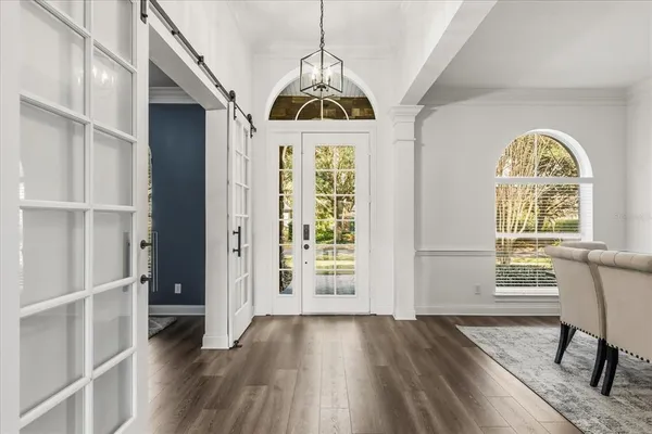 a view of a dining room with furniture and wooden floor
