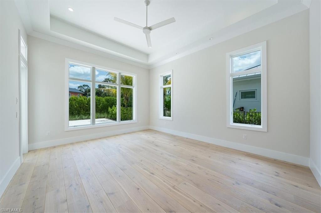 23517 Coconut Road Estero, FL 34134 - Photo 13 of 40 The primary bedroom overlooks the swimming pool and spa backed by lush privacy landscaping.
