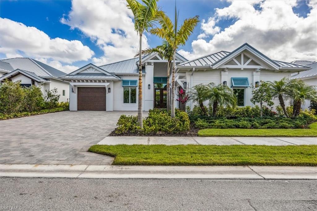 23517 Coconut Road Estero, FL 34134 - Photo 2 of 40 23517 Coconut Landing Drive is a Beach model, featuring a split 2car/1 car garage plan and just under 3200SFUA.