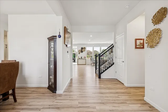 a view of a hallway with wooden floor and staircase