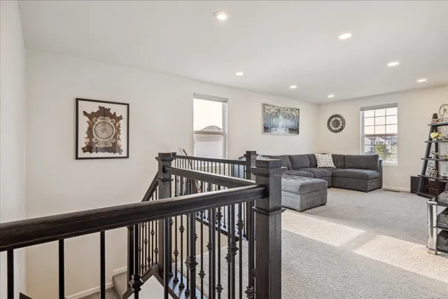 a living room with lots of furniture and a large window
