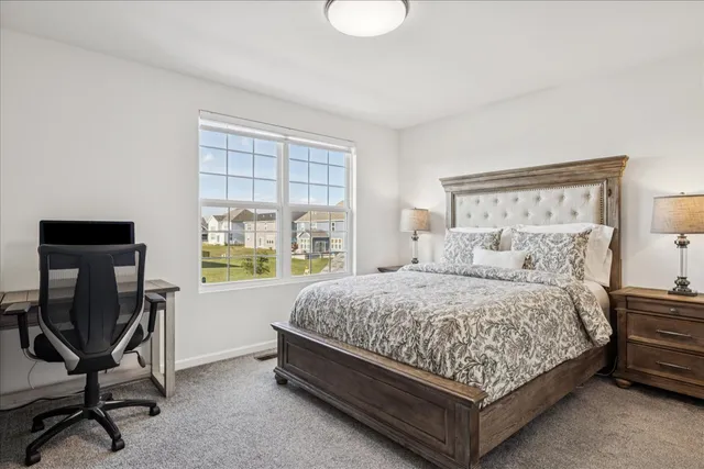 a bedroom with a bed chair and window