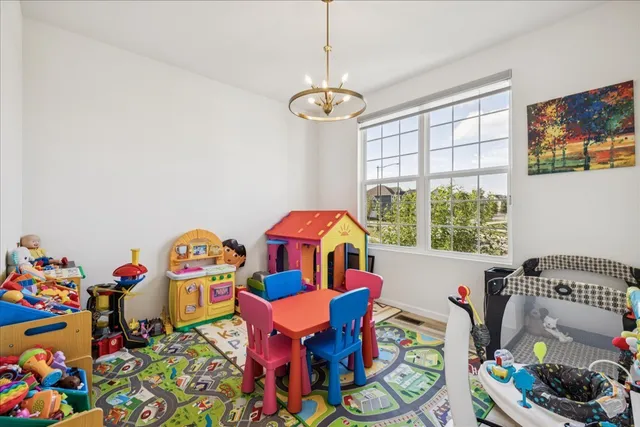 a very nice looking room with a big dining table and a chandelier