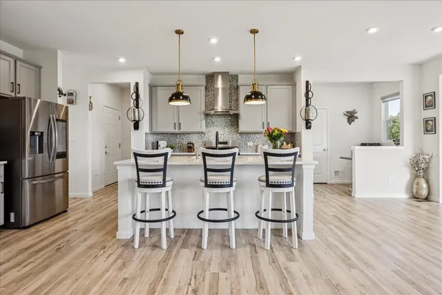 a large kitchen with a table and chairs