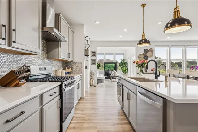 a kitchen with stove a sink and cabinets