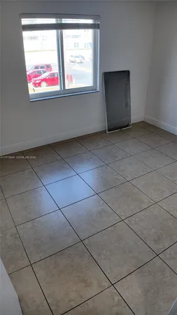 a view of an empty room with windows