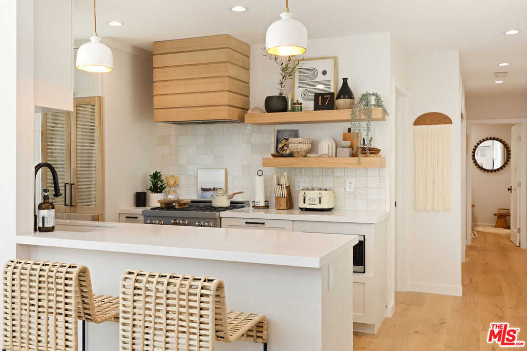 17 Sunset Avenue, Unit 1 Venice, CA 90291 - Photo 5 of 30 a kitchen with stainless steel appliances granite countertop a sink and cabinets