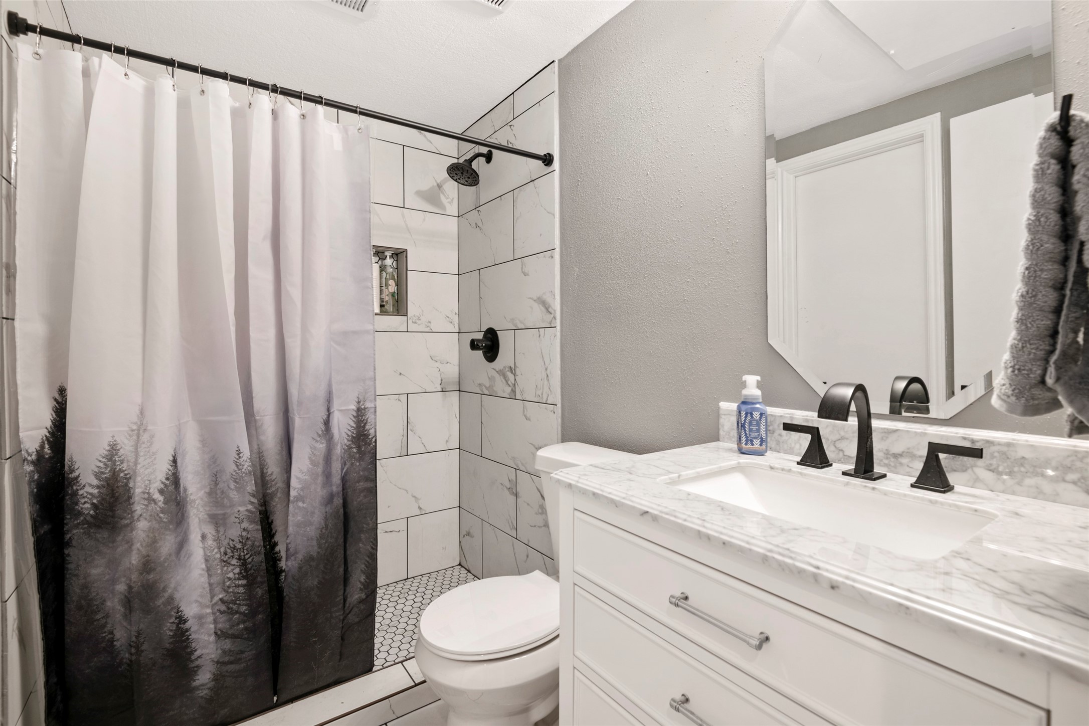 162 April Point Drive South Conroe, TX 77356 - Photo 13 of 26 a bathroom with a sink a toilet a mirror and shower curtain