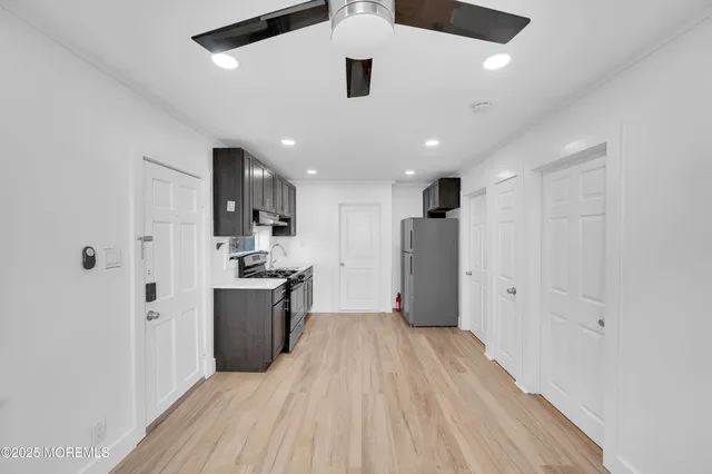 a kitchen with stainless steel appliances granite countertop a refrigerator and a stove top oven