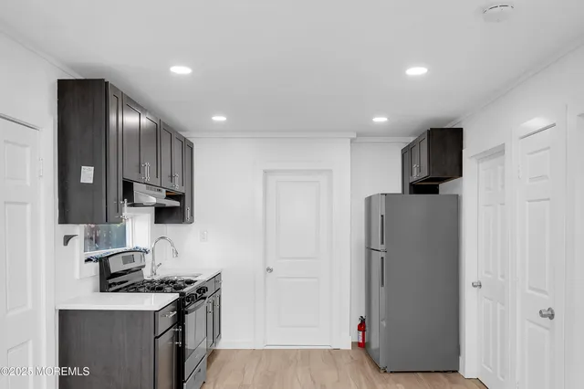 a kitchen with stainless steel appliances granite countertop a refrigerator stove and oven