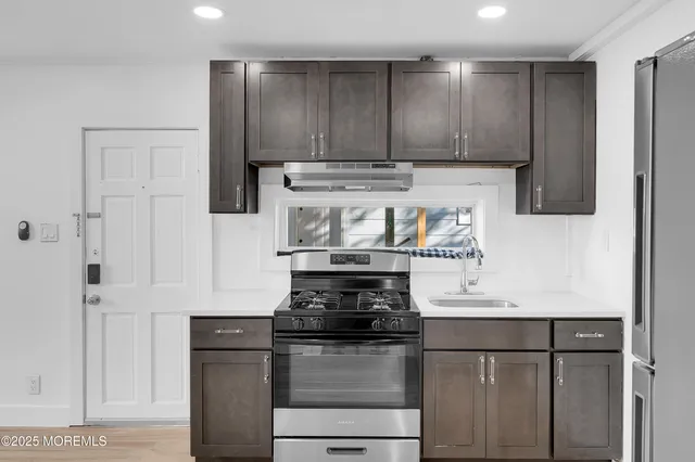 a kitchen with stainless steel appliances granite countertop a stove and a refrigerator