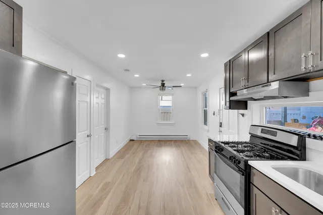 a kitchen with granite countertop a stove and a refrigerator