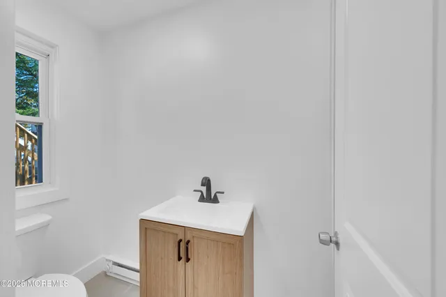 a bathroom with a sink a toilet and vanity