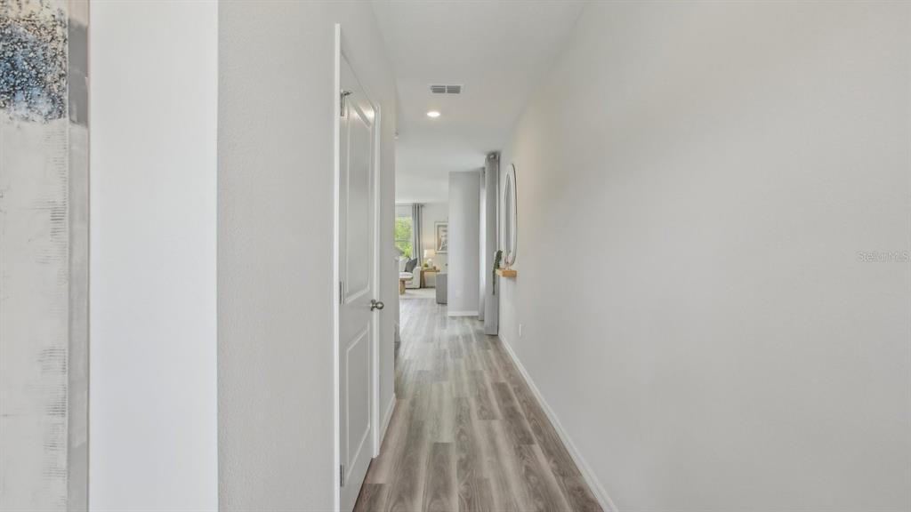 38370 Tea Rose Avenue Zephyrhills, FL 33540 - Photo 16 of 36 a view of a room with wooden floor