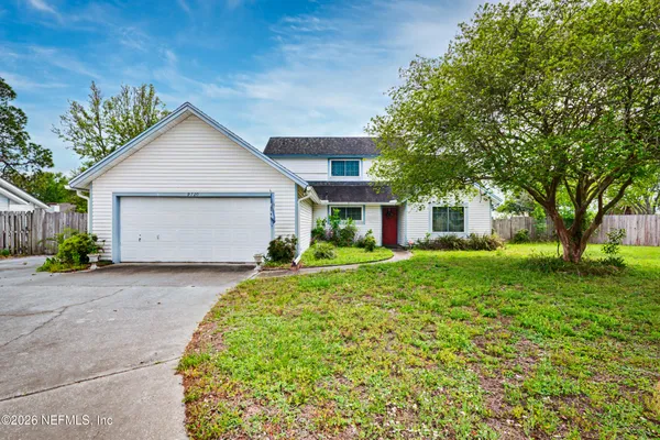 a front view of a house with a yard and garage