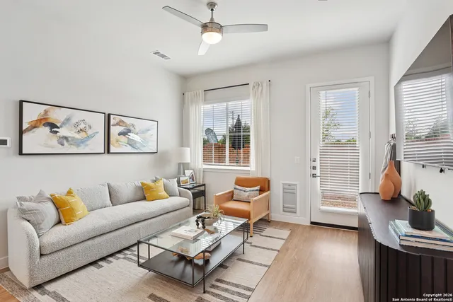 a living room with furniture and wooden floor