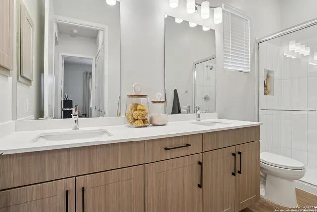a bathroom with a sink double vanity and a mirror
