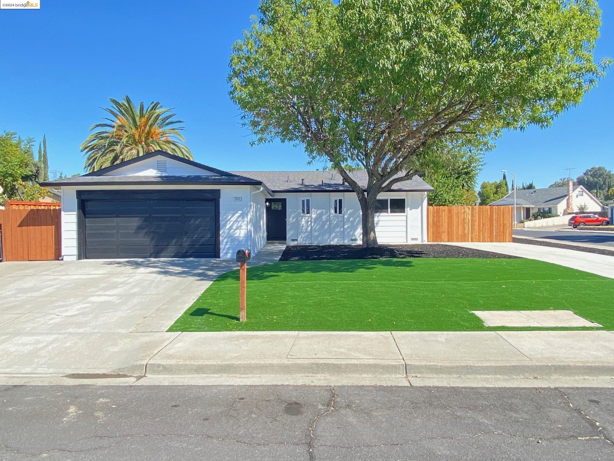 3325 Meadowbrook Road Antioch, CA 94509 - Photo 1 of 1 a front view of a house with a yard and garage
