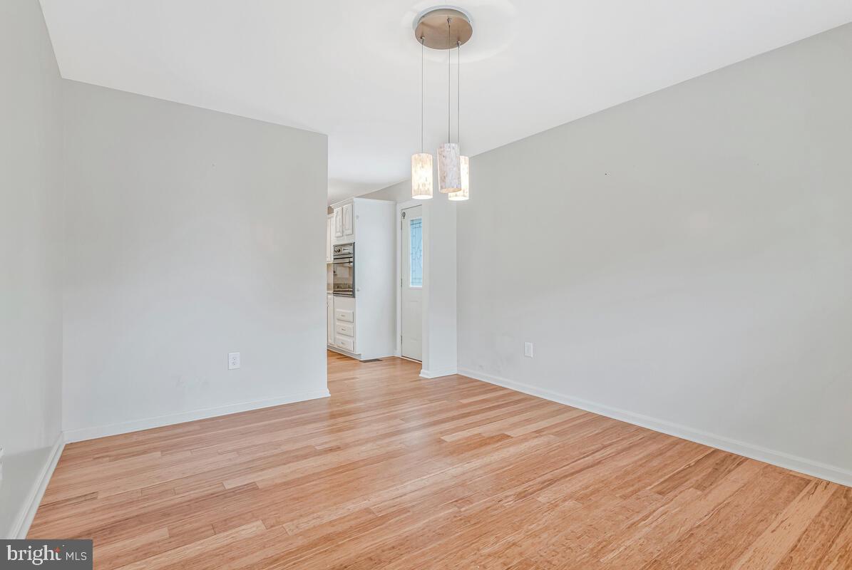 11423 Rawhide Road Lusby, MD 20657 - Photo 16 of 37 a view of an empty room with wooden floor and a window