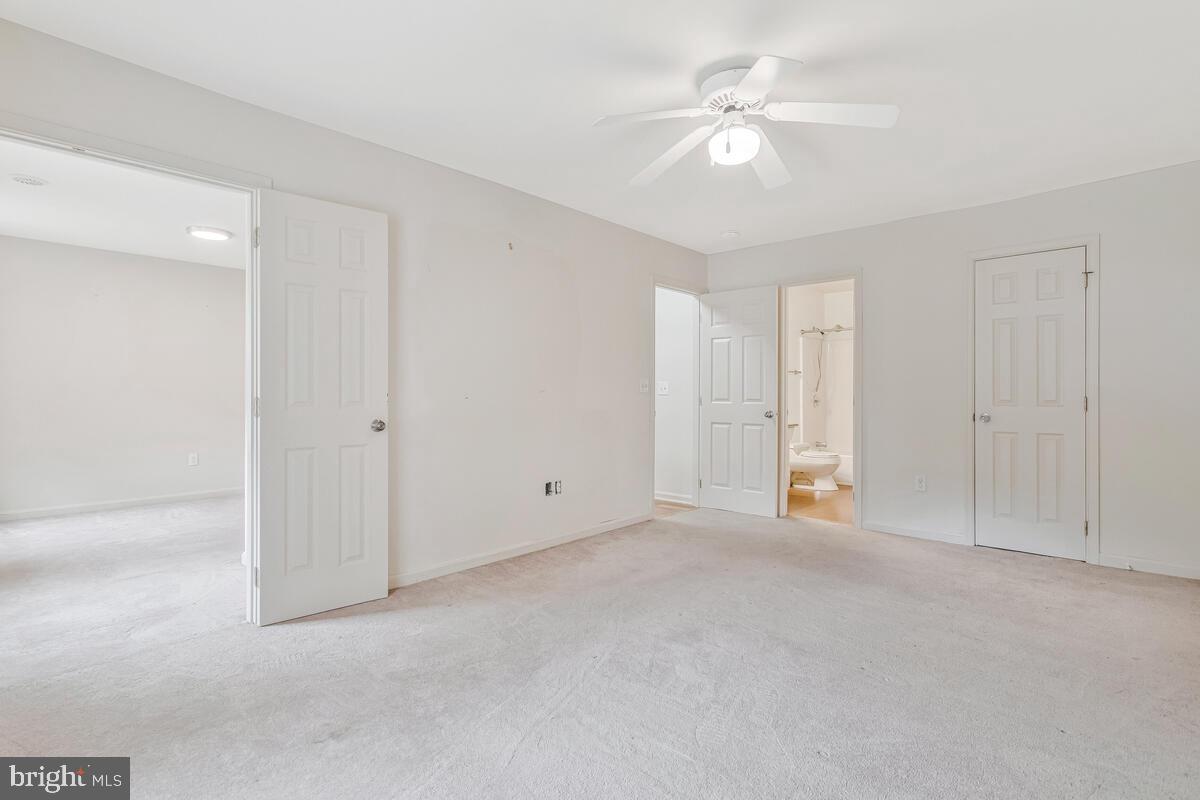 11423 Rawhide Road Lusby, MD 20657 - Photo 21 of 37 a view of an empty room with a ceiling fan