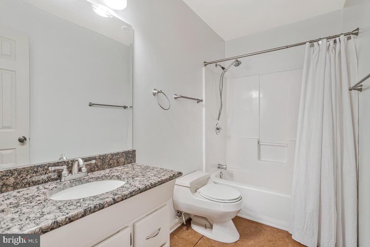 11423 Rawhide Road Lusby, MD 20657 - Photo 25 of 37 a bathroom with a granite countertop sink toilet and shower