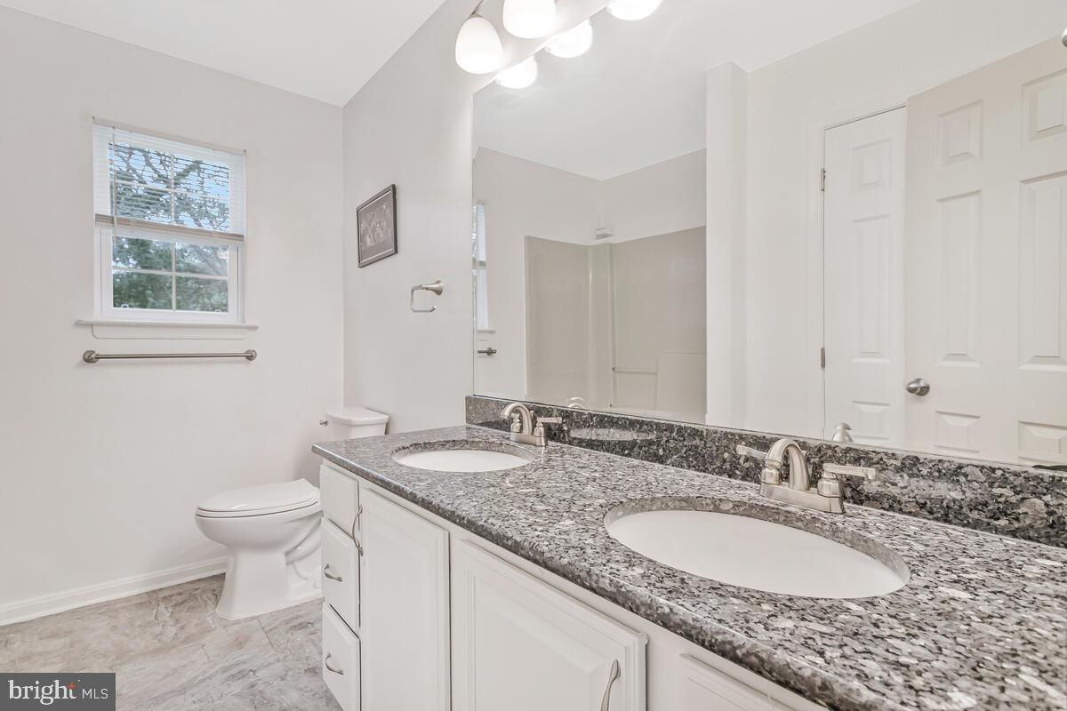 11423 Rawhide Road Lusby, MD 20657 - Photo 30 of 37 a bathroom with a granite countertop double vanity sink and a mirror
