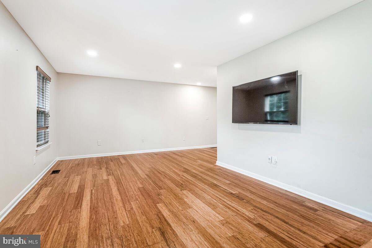 11423 Rawhide Road Lusby, MD 20657 - Photo 4 of 37 a view of an empty room with wooden floor and a window