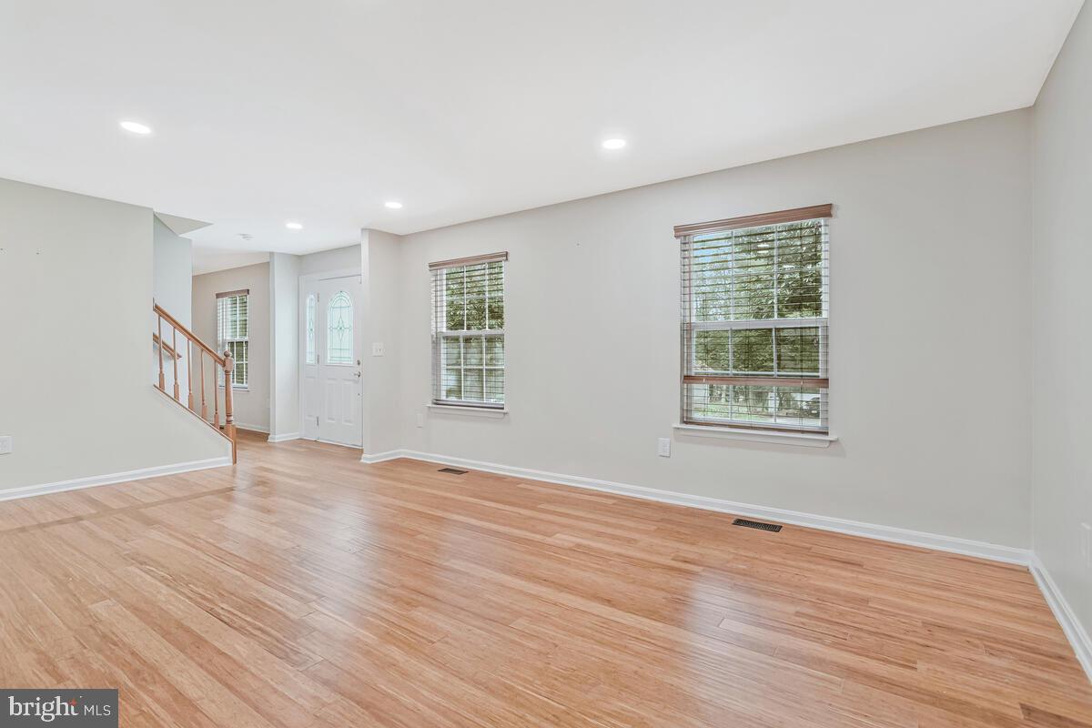 11423 Rawhide Road Lusby, MD 20657 - Photo 5 of 37 an empty room with wooden floor and windows
