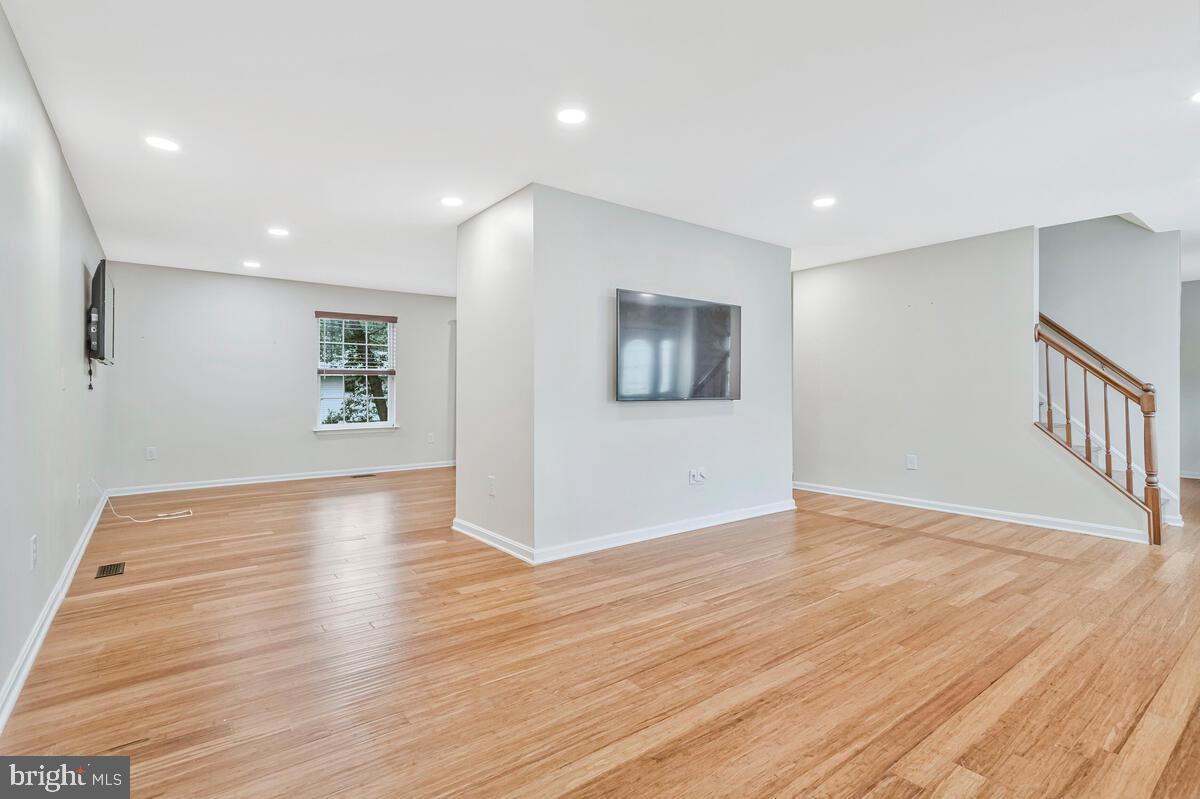 11423 Rawhide Road Lusby, MD 20657 - Photo 6 of 37 a view of an empty room with wooden floor and a window