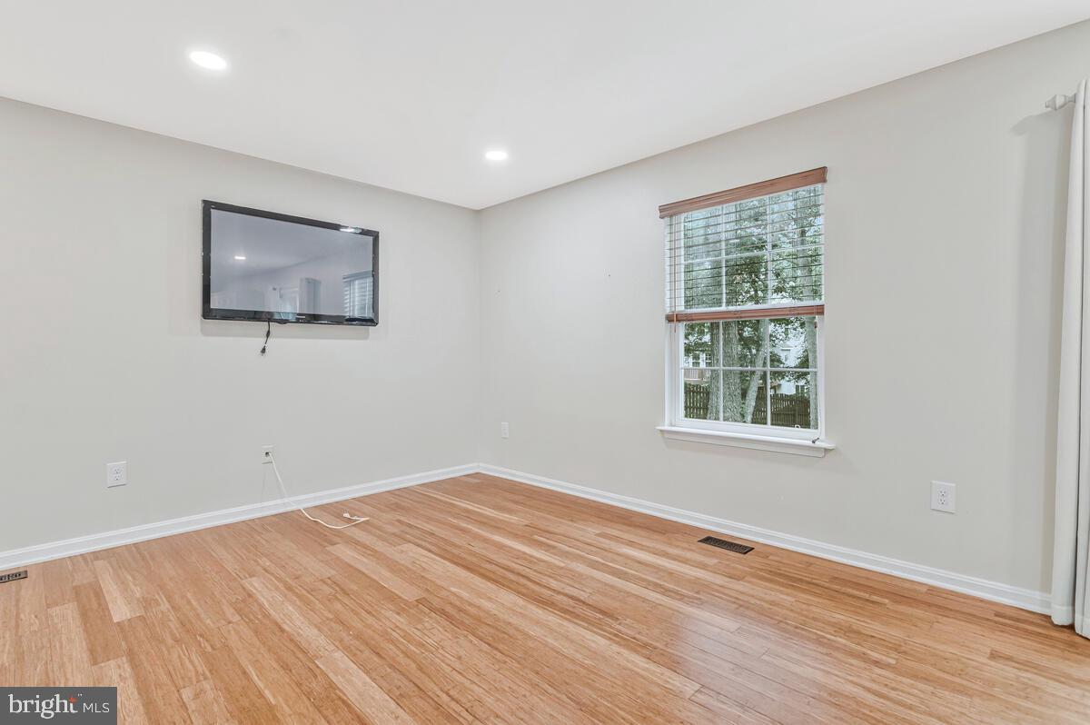 11423 Rawhide Road Lusby, MD 20657 - Photo 8 of 37 a view of an empty room with wooden floor and a window
