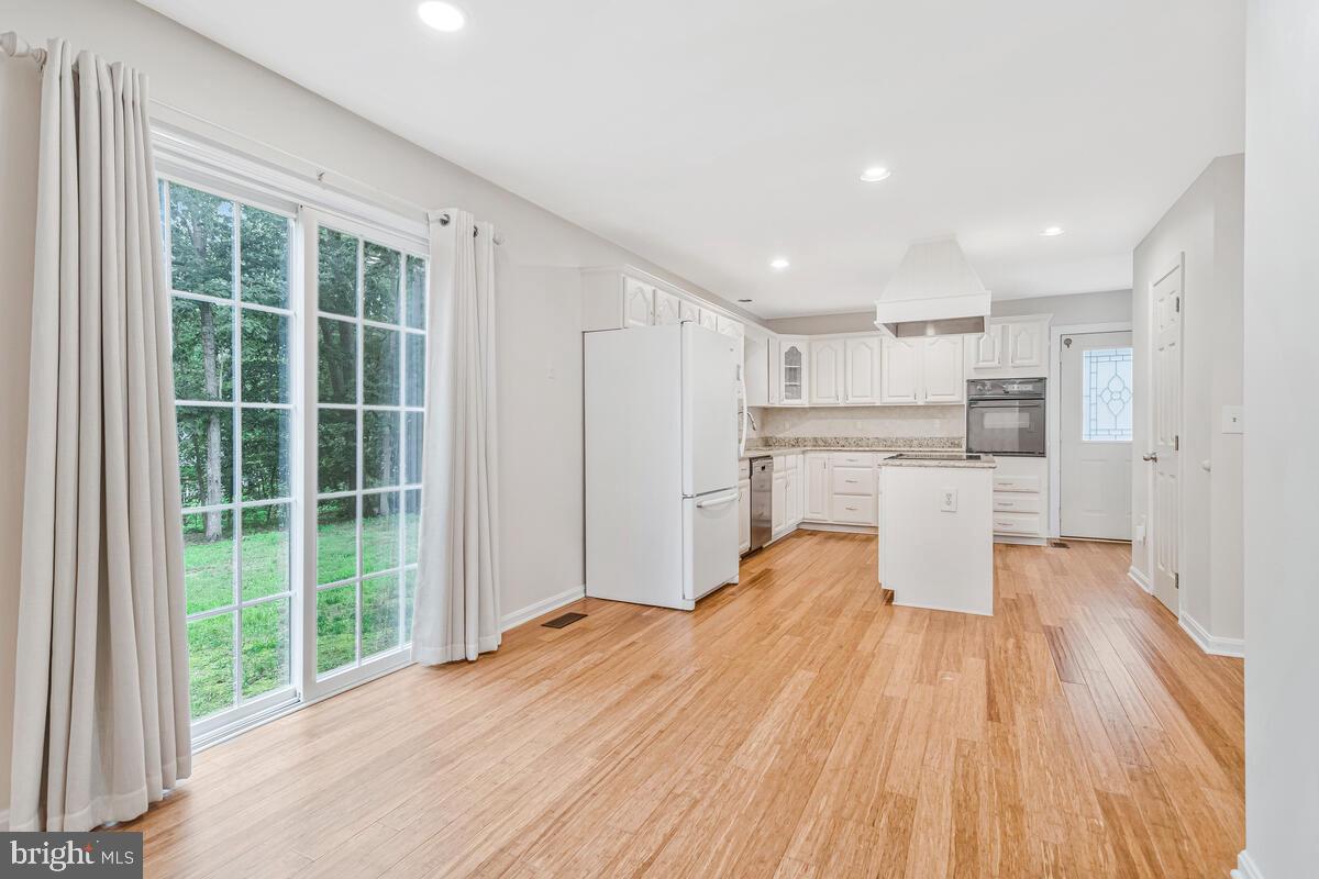 11423 Rawhide Road Lusby, MD 20657 - Photo 9 of 37 a view of a kitchen with wooden floor and electronic appliances