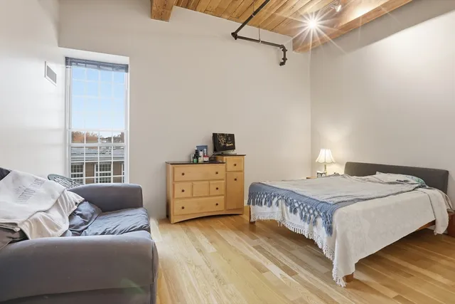 a bedroom with a bed and a window