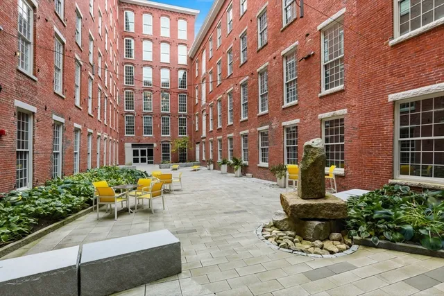 a building outdoor space with patio furniture and potted plants