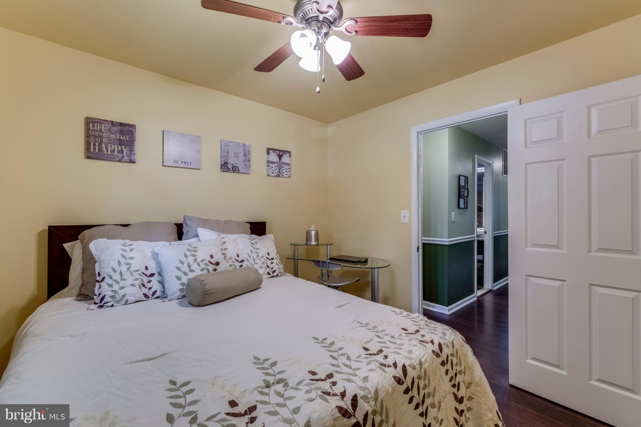 1519 National Road Baltimore, MD 21237 - Photo 11 of 30 a bedroom with a bed and a chandelier