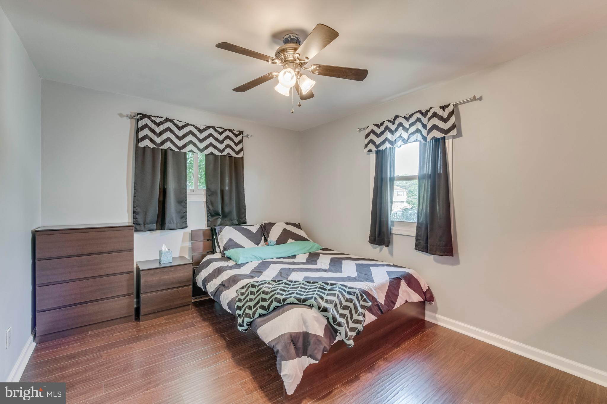 1519 National Road Baltimore, MD 21237 - Photo 14 of 30 a bedroom with a large bed and a chandelier