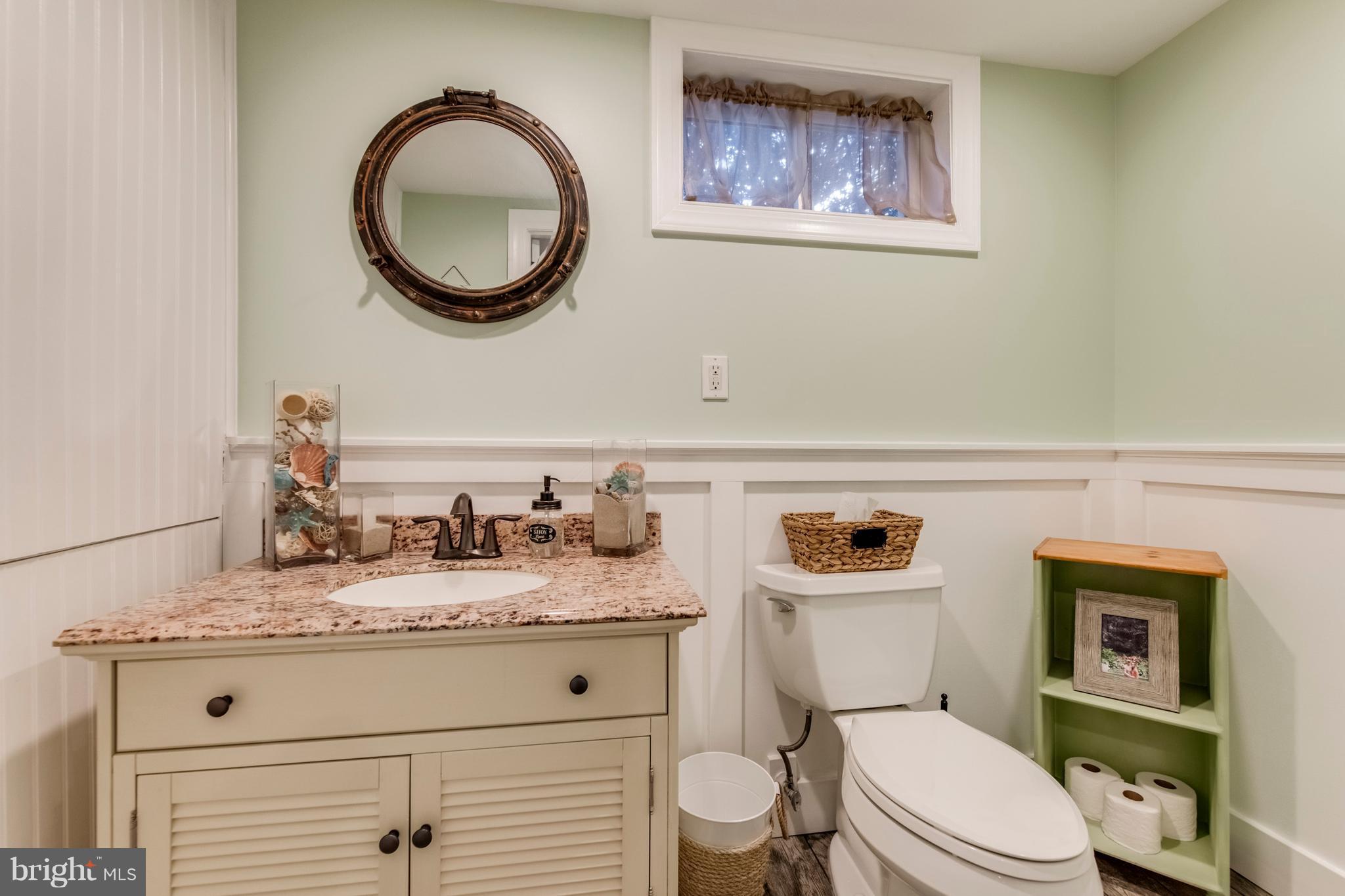 1519 National Road Baltimore, MD 21237 - Photo 19 of 30 a bathroom with a granite countertop toilet sink vanity and mirror
