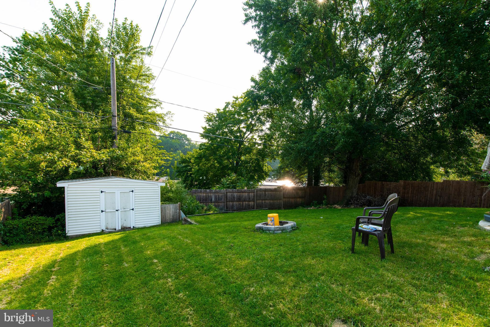 1519 National Road Baltimore, MD 21237 - Photo 27 of 30 a view of a backyard with a garden and fire pit